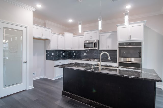 kitchen featuring white cabinets, dark stone countertops, stainless steel appliances, backsplash, and dark wood-style floors