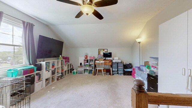 carpeted office space with ceiling fan, vaulted ceiling, and a healthy amount of sunlight
