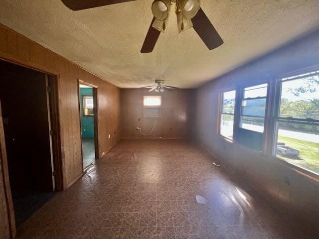 unfurnished room with a ceiling fan, a textured ceiling, and tile patterned floors