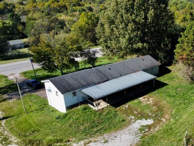 birds eye view of property with a view of trees