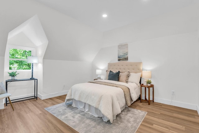 bedroom with light wood-style floors, baseboards, recessed lighting, and lofted ceiling