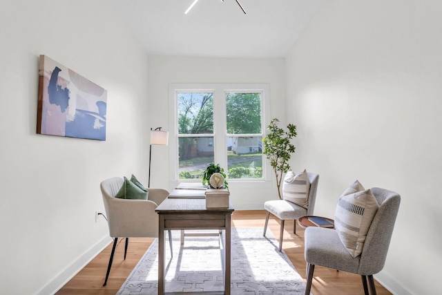 office area with baseboards and wood finished floors