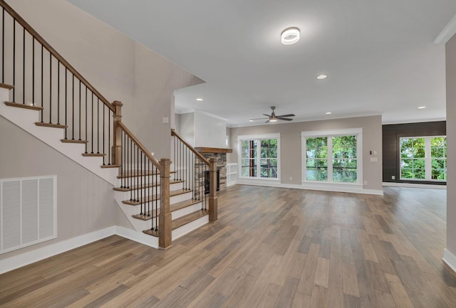 unfurnished living room featuring visible vents, baseboards, ceiling fan, and wood finished floors