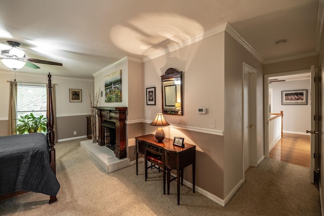 carpeted bedroom with crown molding, baseboards, and a fireplace