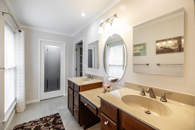 bathroom with crown molding, baseboards, tile patterned flooring, and vanity
