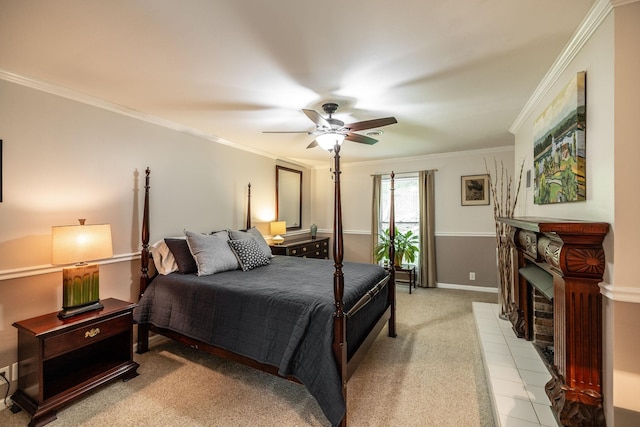 bedroom featuring ornamental molding, a fireplace, ceiling fan, and light colored carpet
