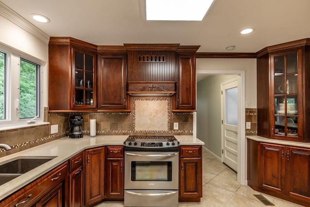 kitchen featuring decorative backsplash, visible vents, a sink, light countertops, and electric stove