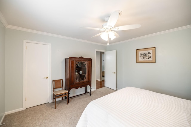 bedroom featuring a ceiling fan, baseboards, light colored carpet, and ornamental molding