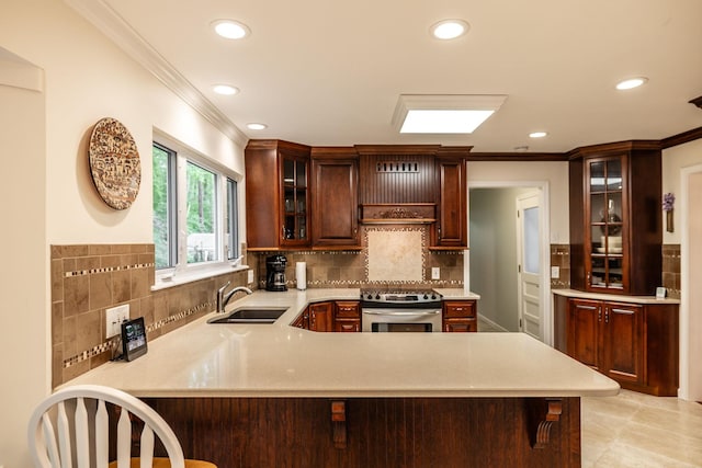kitchen with a sink, light countertops, crown molding, and stainless steel electric range