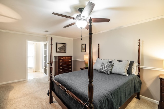 bedroom featuring crown molding, baseboards, a ceiling fan, and light colored carpet