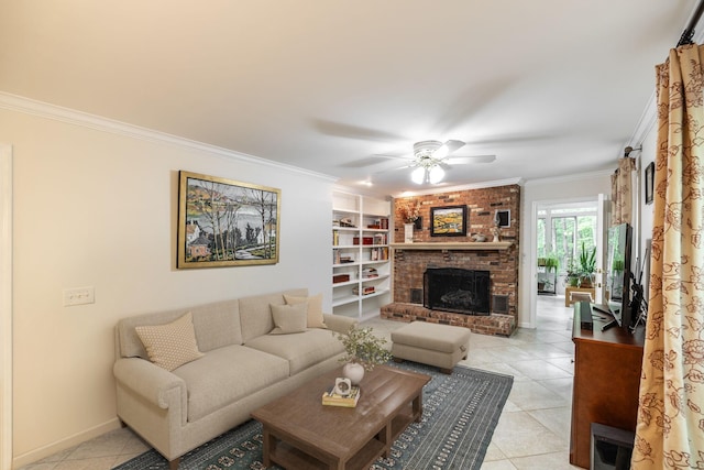 living area with ornamental molding, a fireplace, built in shelves, a ceiling fan, and light tile patterned floors