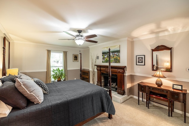 bedroom with ornamental molding, light carpet, a fireplace, baseboards, and ceiling fan