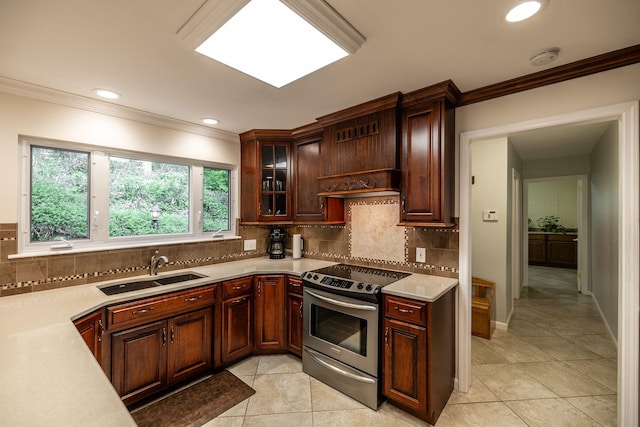 kitchen featuring crown molding, stainless steel electric range, a sink, light countertops, and light tile patterned floors