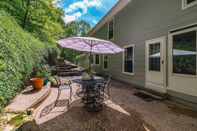 view of patio featuring outdoor dining area and entry steps
