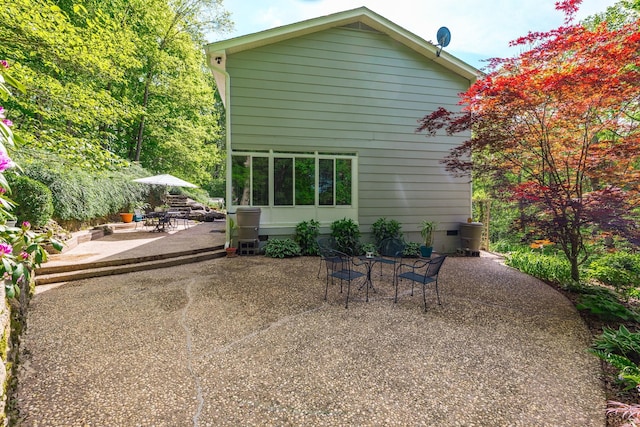 back of property featuring a patio and outdoor dining space