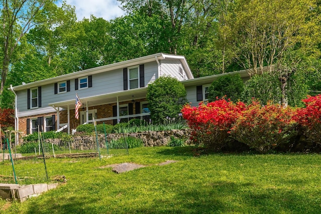 view of front of house with brick siding and a front lawn