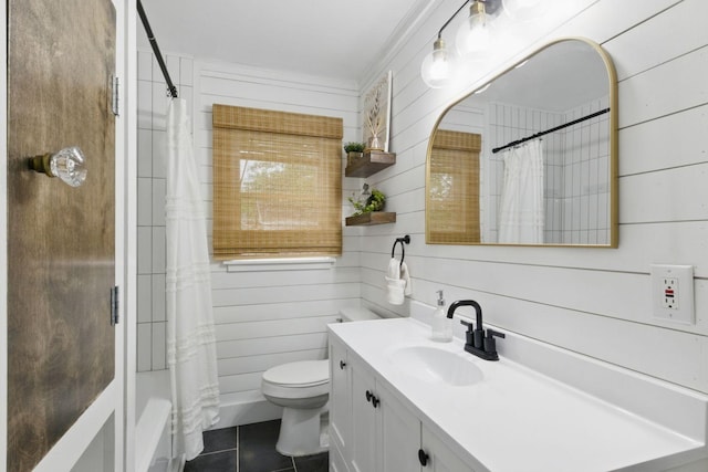 bathroom with wooden walls, toilet, tile patterned flooring, and vanity