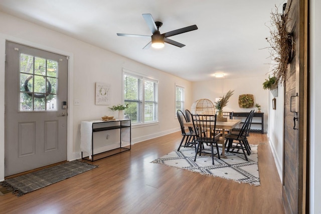 dining area with baseboards, ceiling fan, and wood finished floors