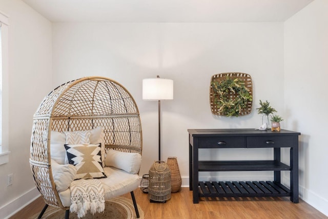 sitting room featuring baseboards and wood finished floors