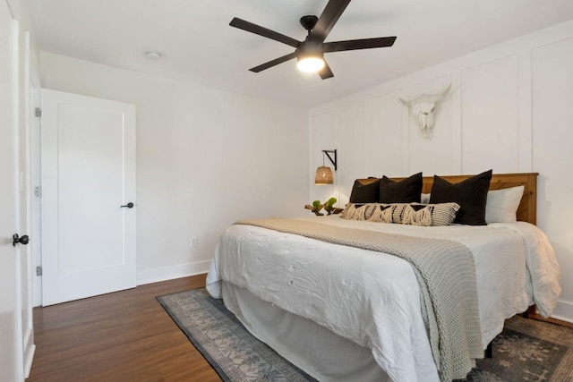 bedroom featuring baseboards, ceiling fan, and wood finished floors