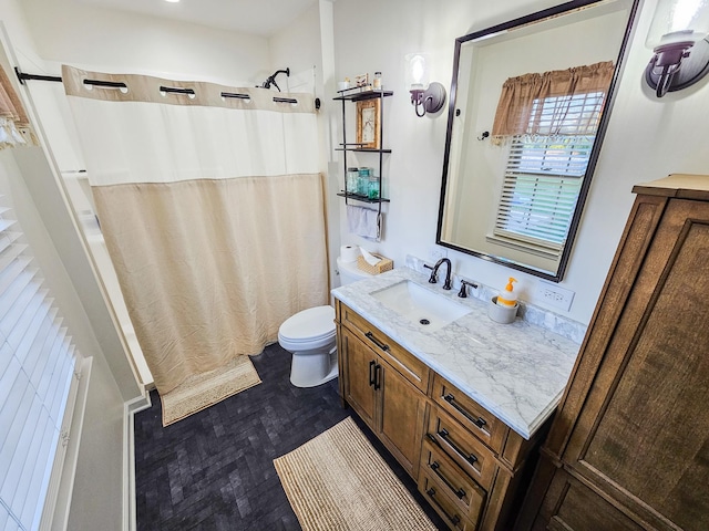 bathroom featuring vanity, toilet, and a shower with shower curtain