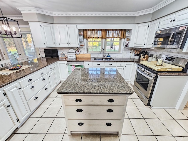 kitchen with open shelves, a sink, light tile patterned floors, ornamental molding, and stainless steel appliances