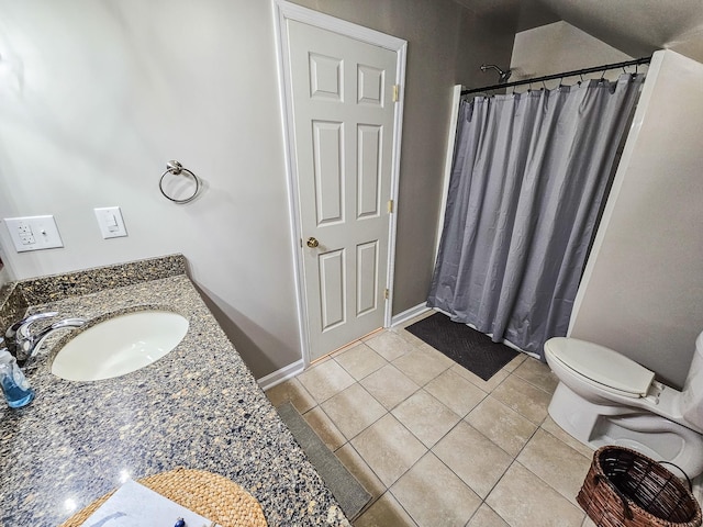 bathroom featuring a sink, tile patterned flooring, toilet, baseboards, and a shower with curtain