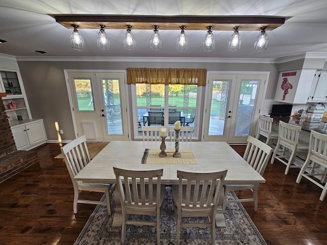 dining space with french doors, ornamental molding, and dark wood-style floors