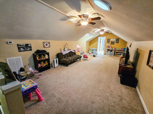game room with visible vents, carpet flooring, a textured ceiling, a ceiling fan, and vaulted ceiling