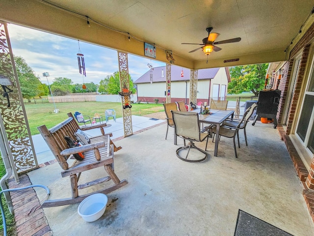 view of patio / terrace featuring fence, a ceiling fan, and outdoor dining space