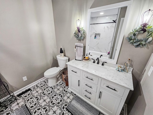 bathroom featuring toilet, baseboards, walk in shower, and vanity