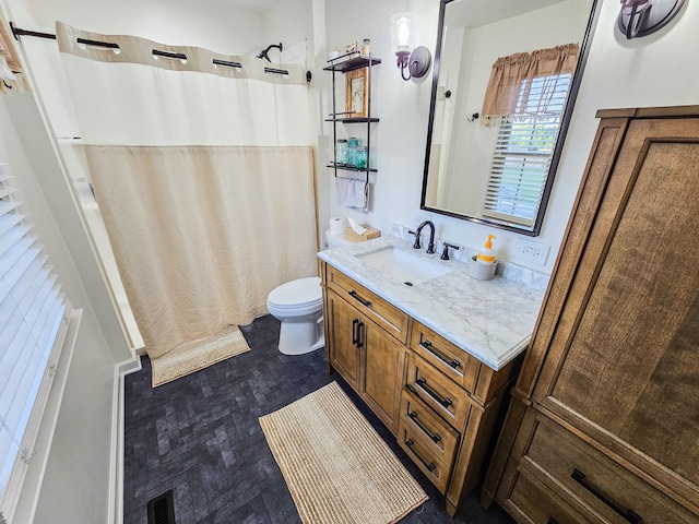 bathroom with vanity, toilet, and a shower with shower curtain