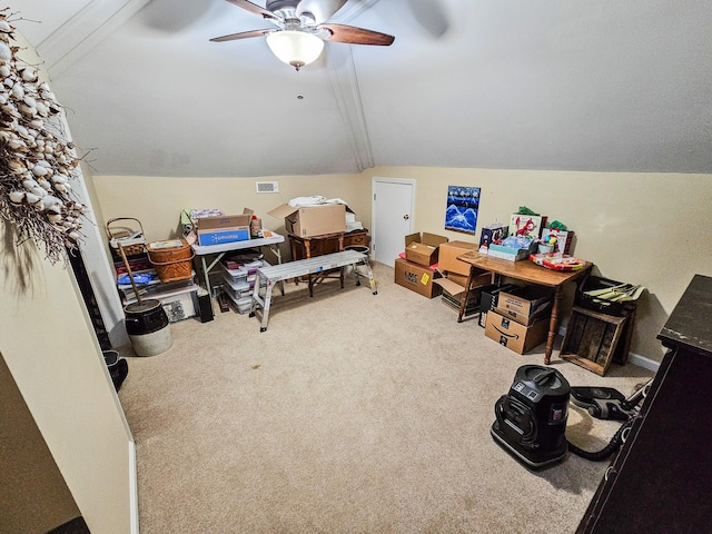 interior space with ceiling fan, vaulted ceiling, carpet flooring, and visible vents