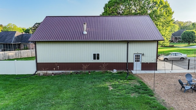 view of outbuilding featuring fence and an outdoor structure