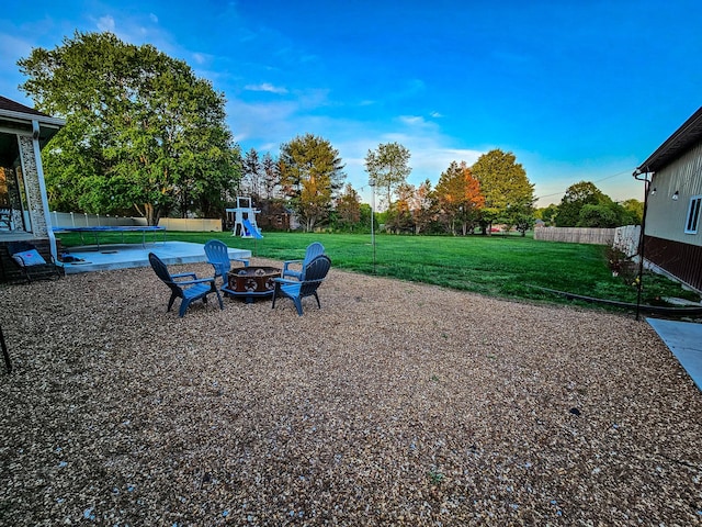 view of yard featuring fence and an outdoor fire pit