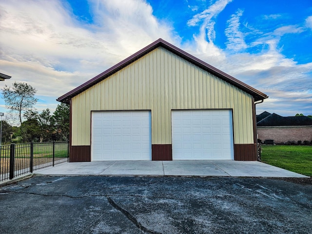 detached garage featuring fence