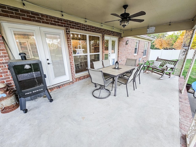 view of patio featuring ceiling fan, fence, and outdoor dining space