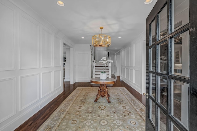 entrance foyer with recessed lighting, a chandelier, and a decorative wall