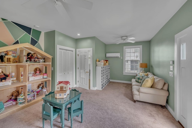 playroom with carpet floors, a ceiling fan, baseboards, and a wall unit AC