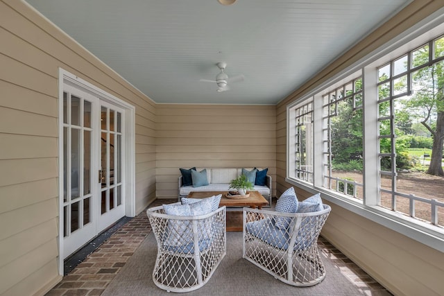 sunroom / solarium featuring ceiling fan, a wealth of natural light, and french doors