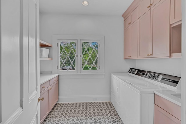 laundry room with cabinet space, recessed lighting, baseboards, light floors, and washer and clothes dryer