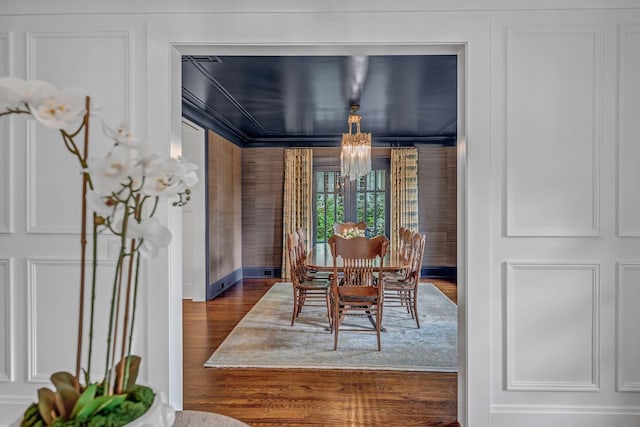 dining room with baseboards, dark wood-style floors, and a chandelier