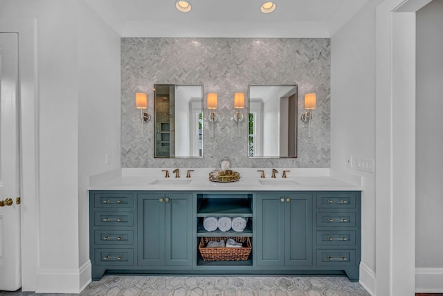 full bathroom with a sink, baseboards, and double vanity