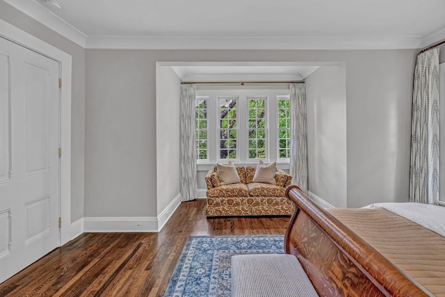 bedroom with baseboards, ornamental molding, and wood finished floors