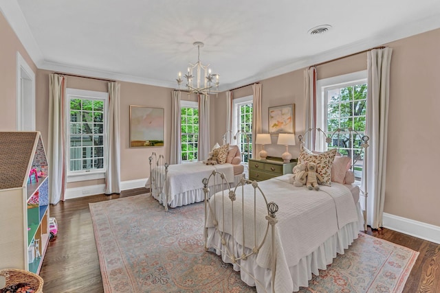 bedroom featuring visible vents, ornamental molding, wood finished floors, baseboards, and a chandelier