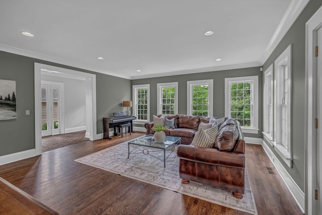 living area featuring baseboards, ornamental molding, and wood finished floors