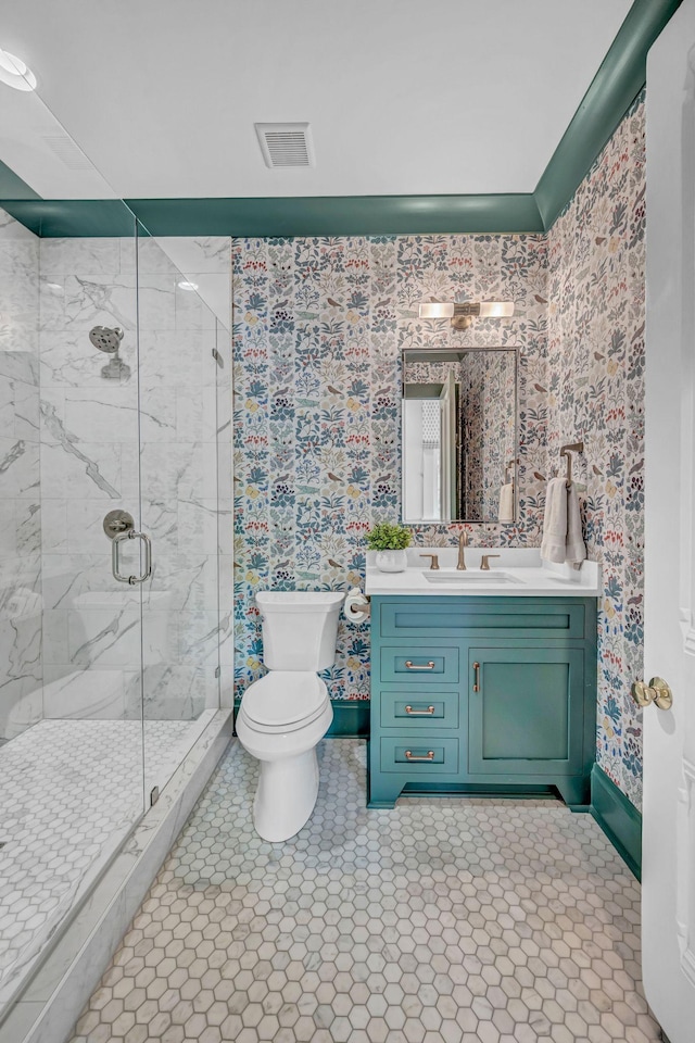 full bathroom with visible vents, vanity, toilet, baseboards, and a marble finish shower