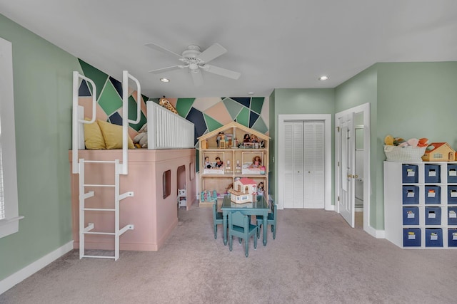 rec room featuring baseboards, a ceiling fan, and carpet