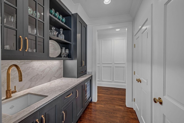 corridor featuring recessed lighting, a sink, and dark wood-type flooring