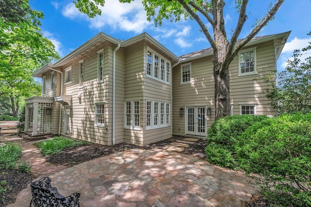 rear view of property featuring a patio area and french doors